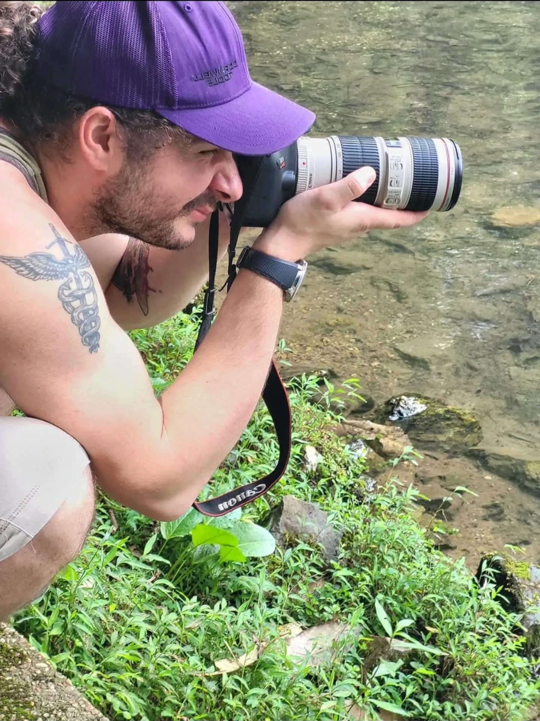 A Lakeland Cabaret photographer working beside a stream